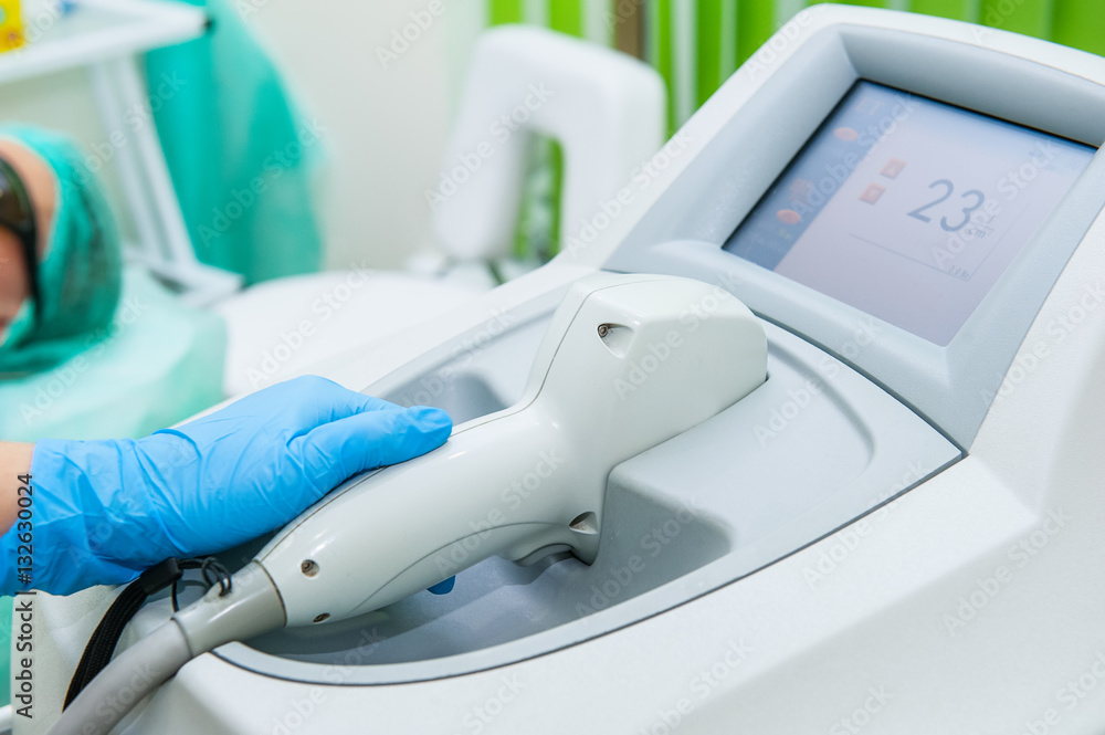 Beautician specialist adjusts laser equipment for cosmetic procedures in cosmeticians office, close up Beautician specialist adjusts laser equipment for cosmetic procedures in cosmeticians office, close up