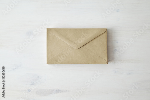 Brown kraft paper post envelope on wood table