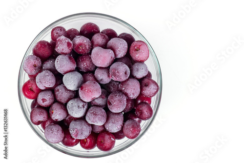 Plate frozen red sweet ripe cherries on a white background. Harvesting of berries for the winter.
