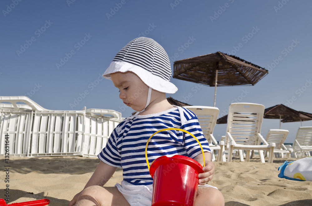 Beautiful baby playing on the sand in Bulgarian resort Beautiful baby playing on the sand in Bulgarian resort