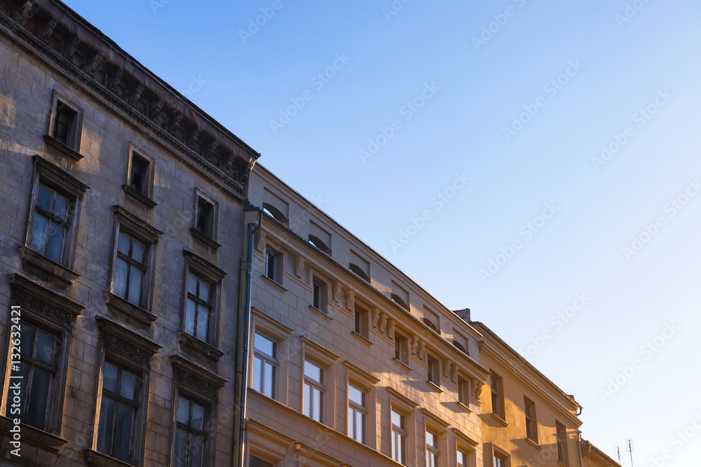 Old residential tenement houses during sunset.