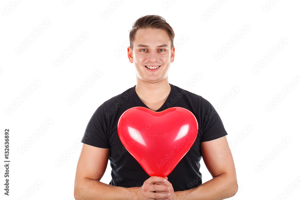 Handsome guy holding a heart-shaped balloon Handsome guy holding a heart-shaped balloon