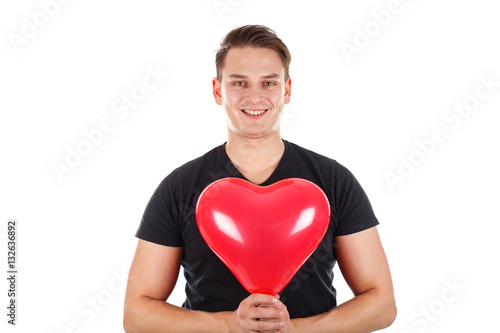 Handsome guy holding a heart-shaped balloon © Ocskay Mark