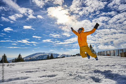 Man jumping on ski vacation