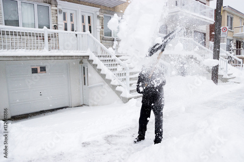 Shovelling Snow in a Winter Snow Storm in Montreal Quebec Canada North