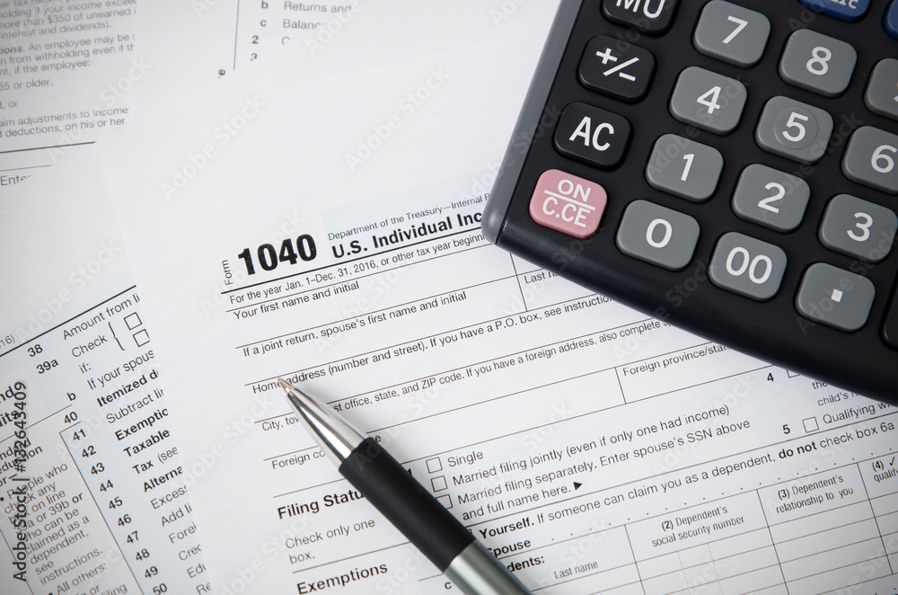 US tax form 1040 with pen and calculator US tax form 1040 with pen and calculator