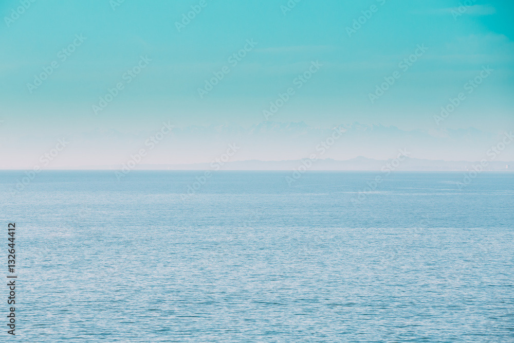 Calm Sea Ocean And Blue Clear Sky Background. Gently Blue Color Calm Sea Ocean And Blue Clear Sky Background. Gently Blue Color
