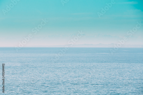 Calm Sea Ocean And Blue Clear Sky Background. Gently Blue Color