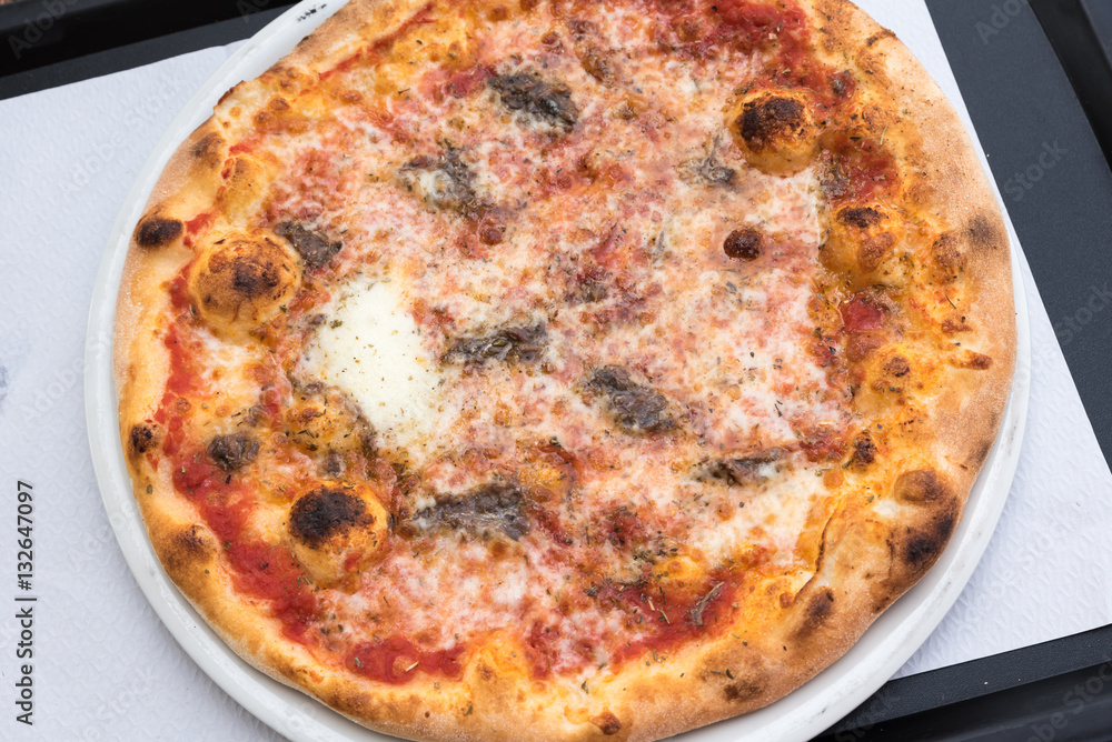 Tasty Italian pizza with anchovies Tasty Italian pizza with anchovies