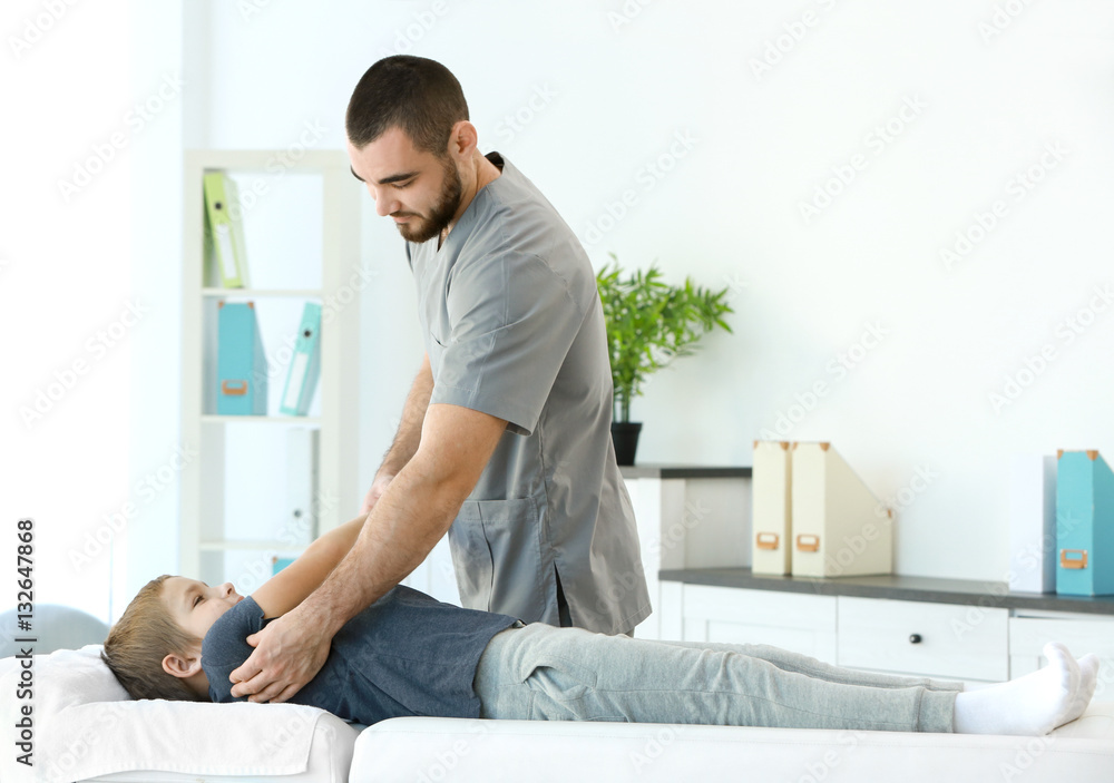 © Africa Studio - Physiotherapist working with patient in clinic