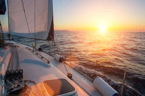 Sail yachts in the Sea. Luxury boat during sunset.
