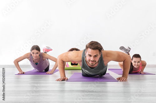 Group of people doing push-ups in yoga class