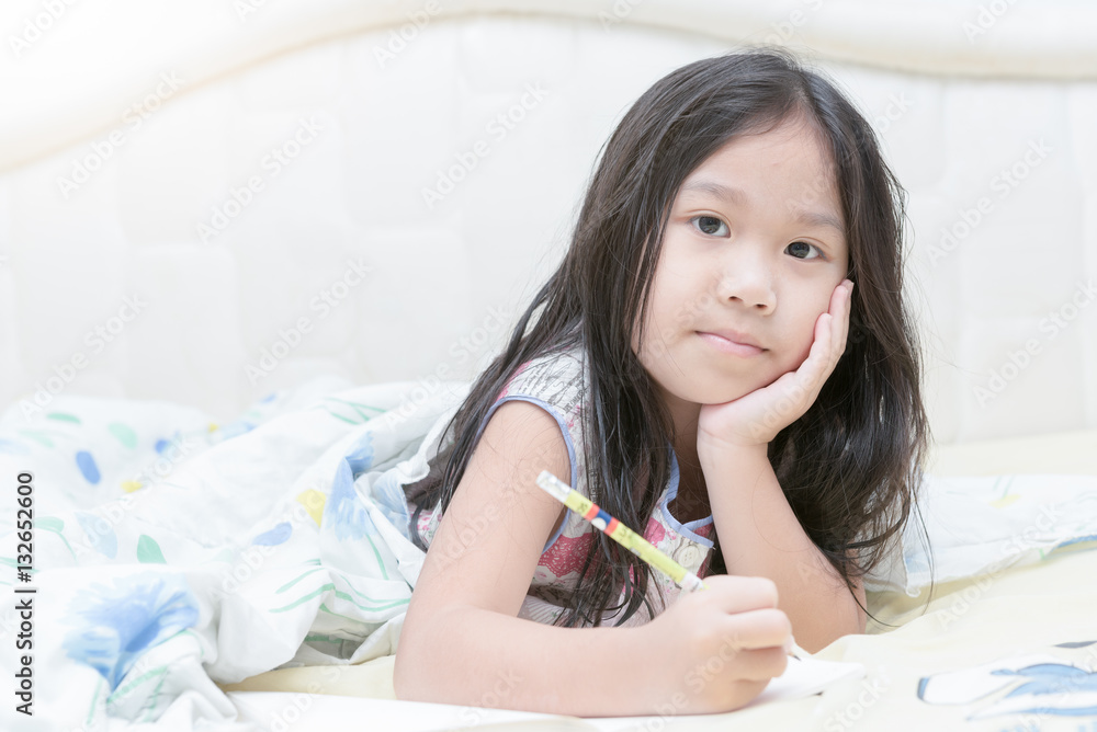 asian girl writing to diary on the bed asian girl writing to diary on the bed