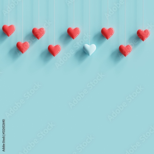 Hanging blue tiny heart contrast with many red hearts on pastel blue background. minimal concept idea.