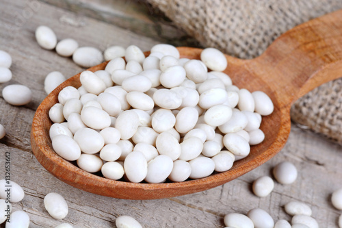 Wooden spoon with white beans