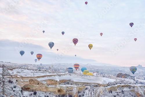 Group of Hot Air Balloons Flying Over Cappadocia During Sunrise in Turkey