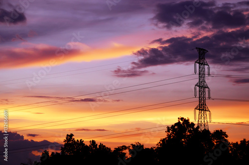 silhouette of electrical pole with sunset sky