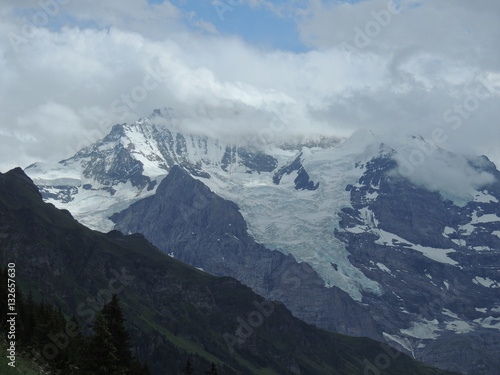 Alpine glacier with mountain peak hidden in the clouds © R. S.