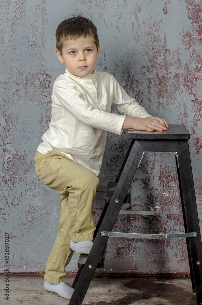 Little baby boy in plaid shorts climbs the ladder ladder
Little baby boy in plaid shorts climbs the ladder ladder
