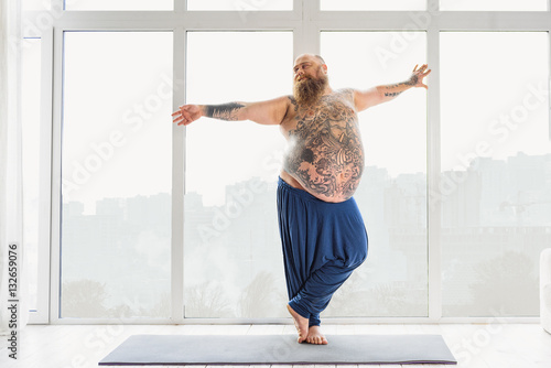 Fototapeta Naklejka Na Ścianę i Meble -  Man doing exercises on a yoga mat