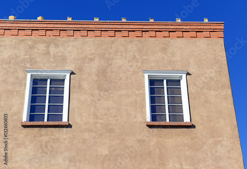 Traditional Pueblo style Adobe Architecture usually in earth tones, referred to as Old Santa Fe Style, characteristic of buildings in New Mexico, USA © nyker