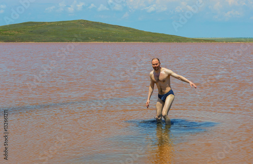 Man in Salt Lake Koyashskoe Elkenskoe. Opuksky Reserve