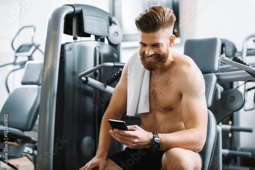 Smiling sporty man in gym
