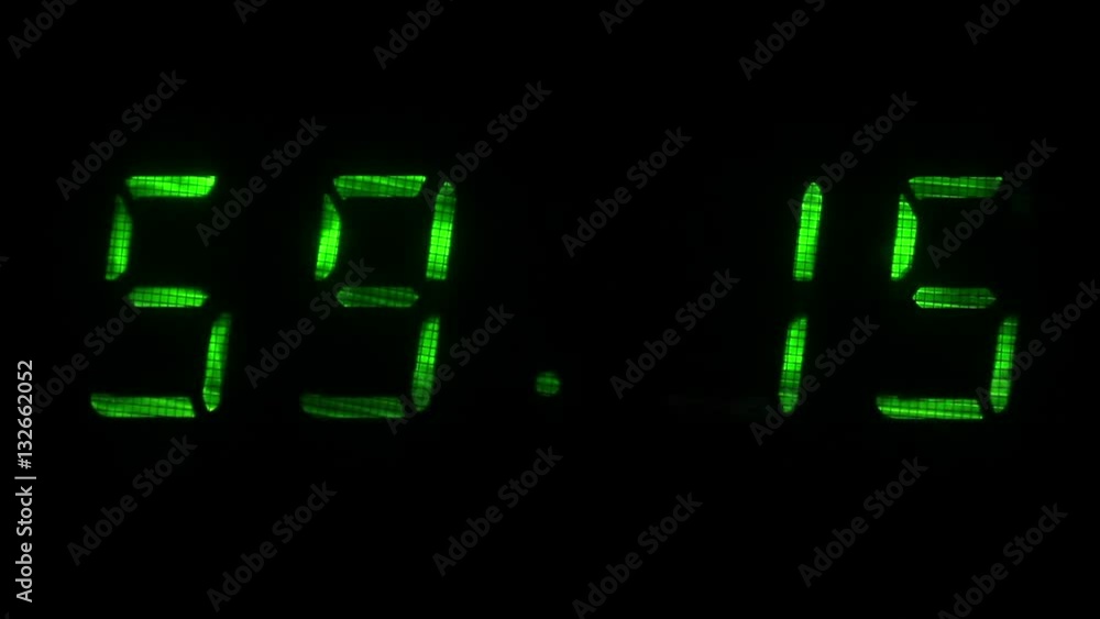 Digital clock with fluorescent display shows the time of 59 minutes 10 seconds to 59 minutes 40 seconds in the green on a black background Digital clock with fluorescent display shows the time of 59 minutes 10 seconds to 59 minutes 40 seconds in the green on a black background