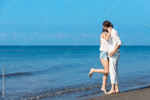 romance on vacation  couple in love on the beach flirting