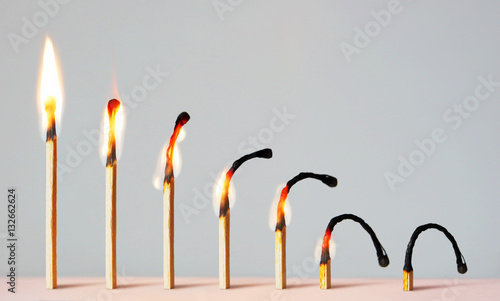 Concept of different phases in human life. Abstract image with burning matches photo