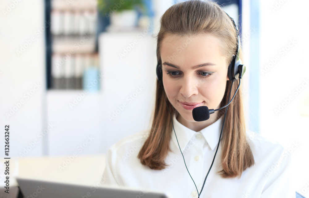 Beautiful young female call center operator with headset in office Beautiful young female call center operator with headset in office