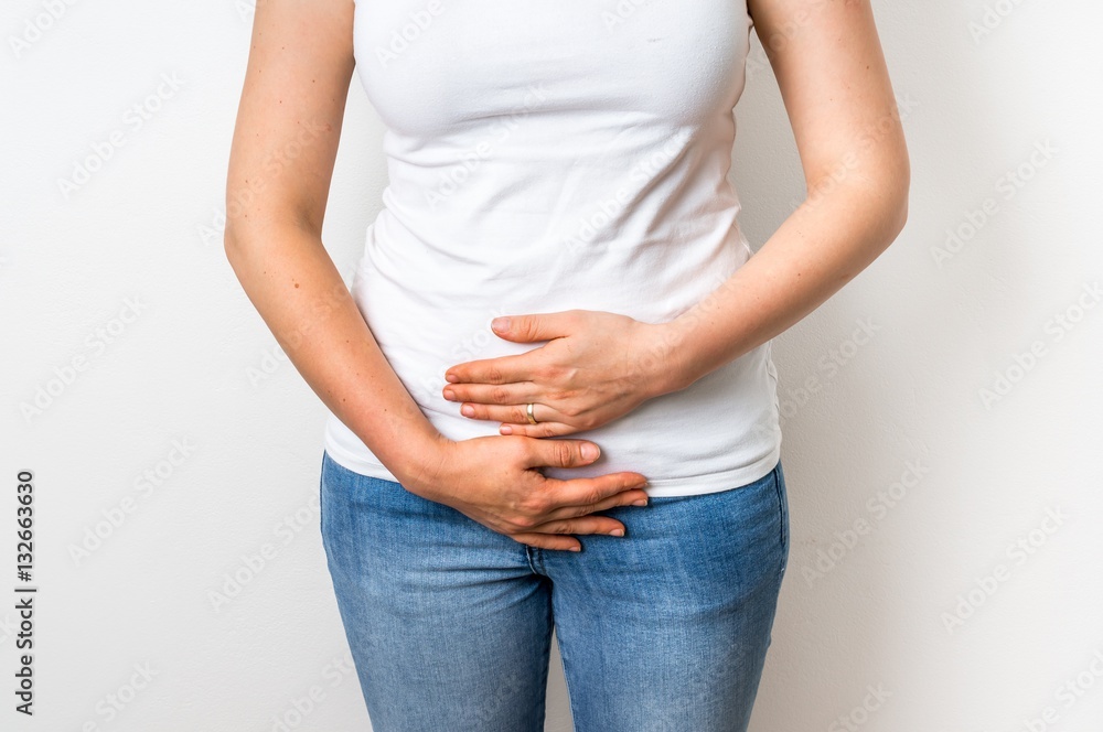 Woman with menstrual pain is holding her aching belly Woman with menstrual pain is holding her aching belly