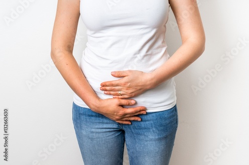 Woman with menstrual pain is holding her aching belly © andriano_cz