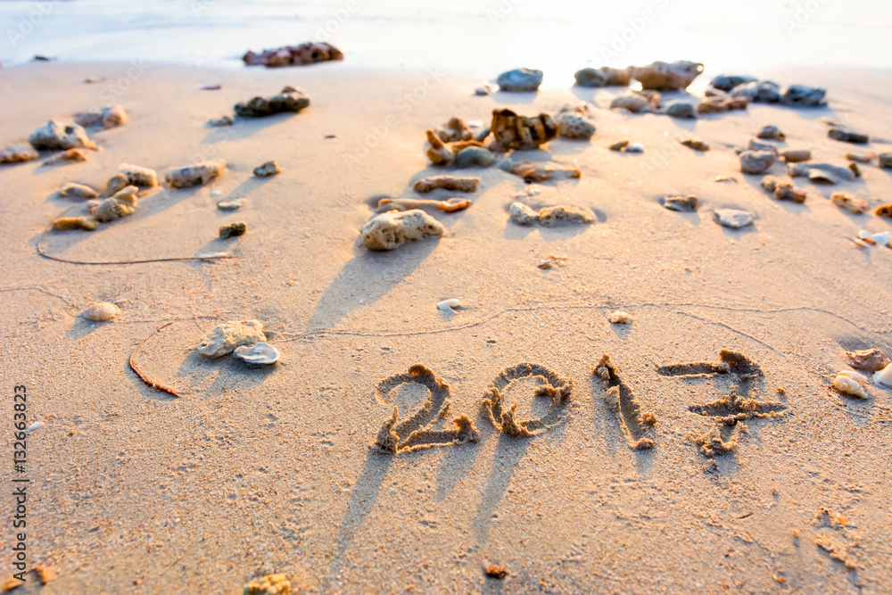 Fototapeta premium Year 2017 written at the sand beach