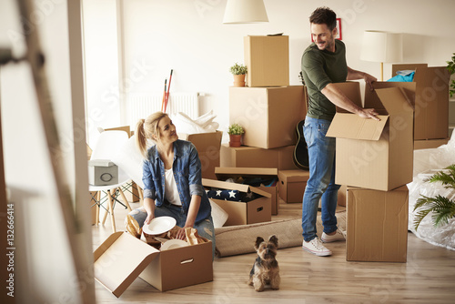 Young couple in new apartment with small dog