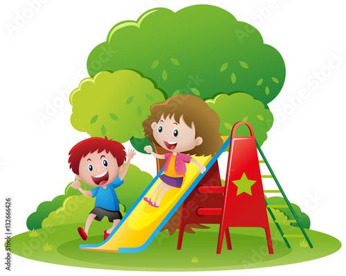 Two kids playing slide in the park