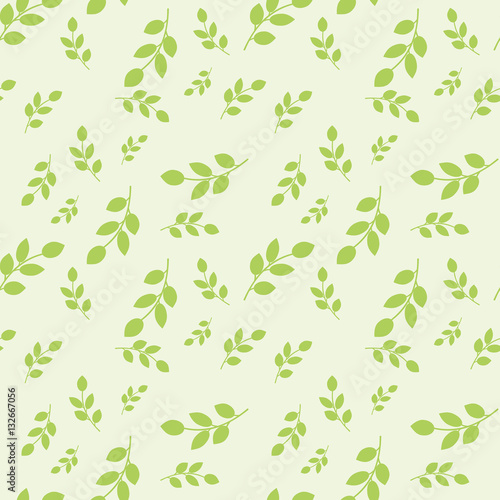 Seamless pattern with leaves placed randomly on light green background
