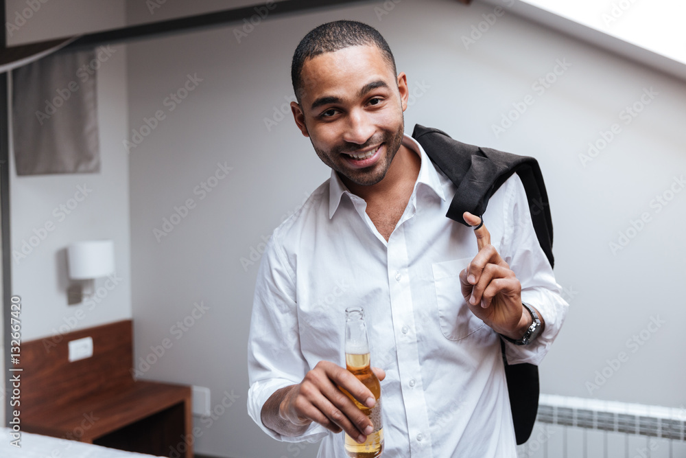 African man in shirt with beer African man in shirt with beer