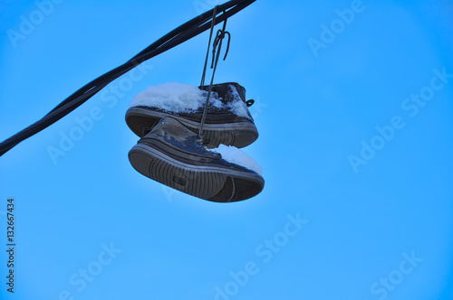 Suspended shoes covered with snow