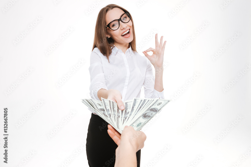 Smiling happy business woman accepting money offering or bribe Smiling happy business woman accepting money offering or bribe