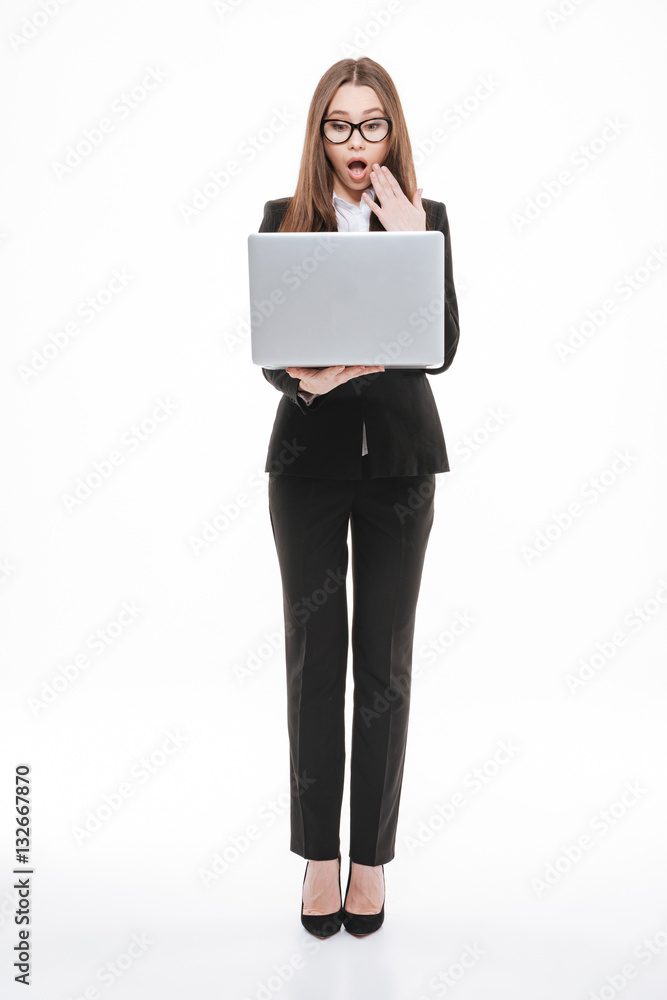 Portrait of a surprised smart businesswoman looking at laptop Portrait of a surprised smart businesswoman looking at laptop