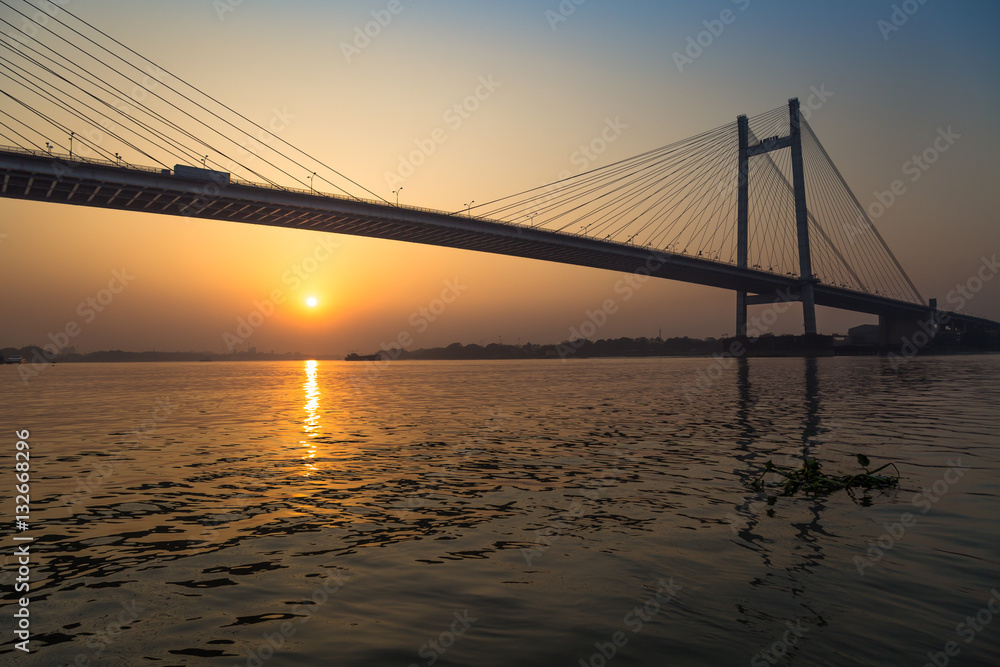 Vidyasagar Setu the longest cable bridge in India at sunset. Photograph taken from a boat near Princep ghat, Kolkata. Vidyasagar Setu the longest cable bridge in India at sunset. Photograph taken from a boat near Princep ghat, Kolkata.