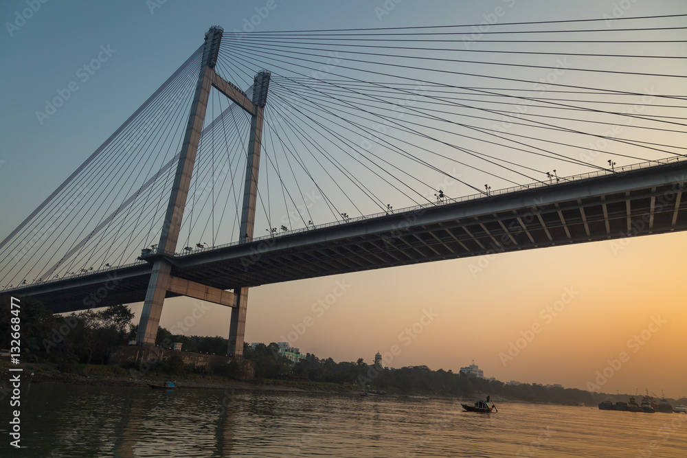 Vidyasagar setu (bridge) as seen from a boat at twilight on river Hooghly, Kolkata, India.
