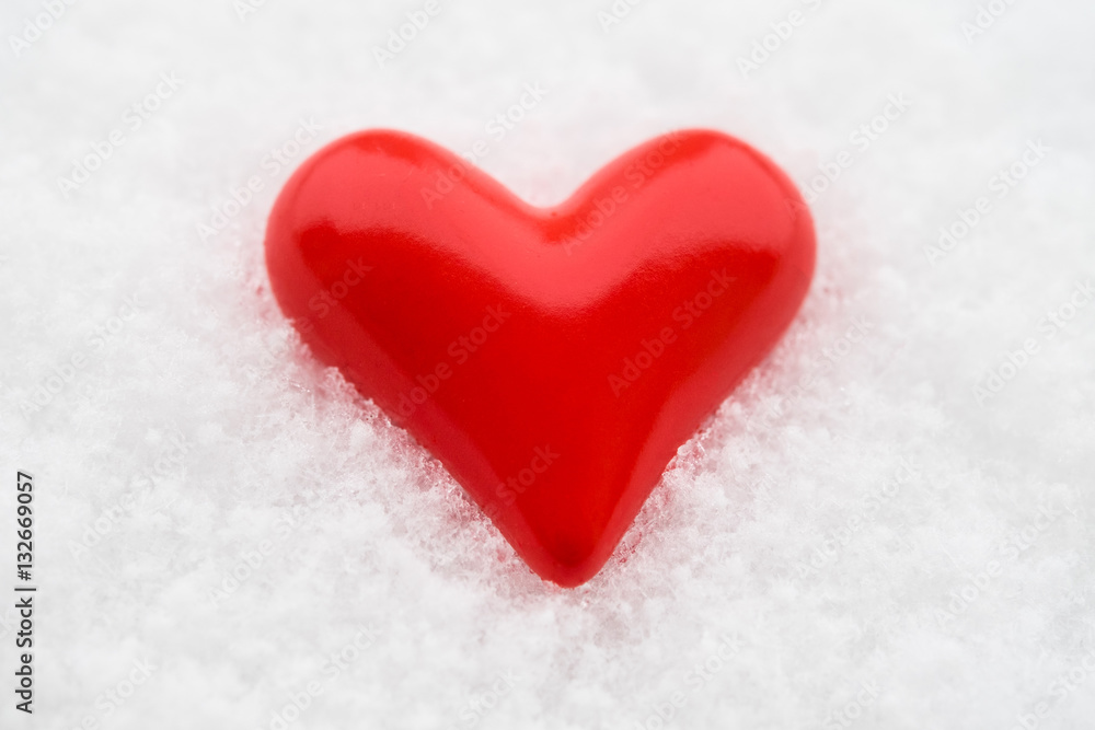 Ceramic red heart on the fresh snow Ceramic red heart on the fresh snow