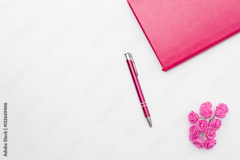 pink diary pen roses on a white background, business minimal concept for women. Flat lay, top view.