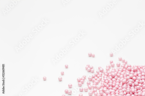 pink sprinkles on a white background. Festive background for Valentine's day, birthday, holiday, party