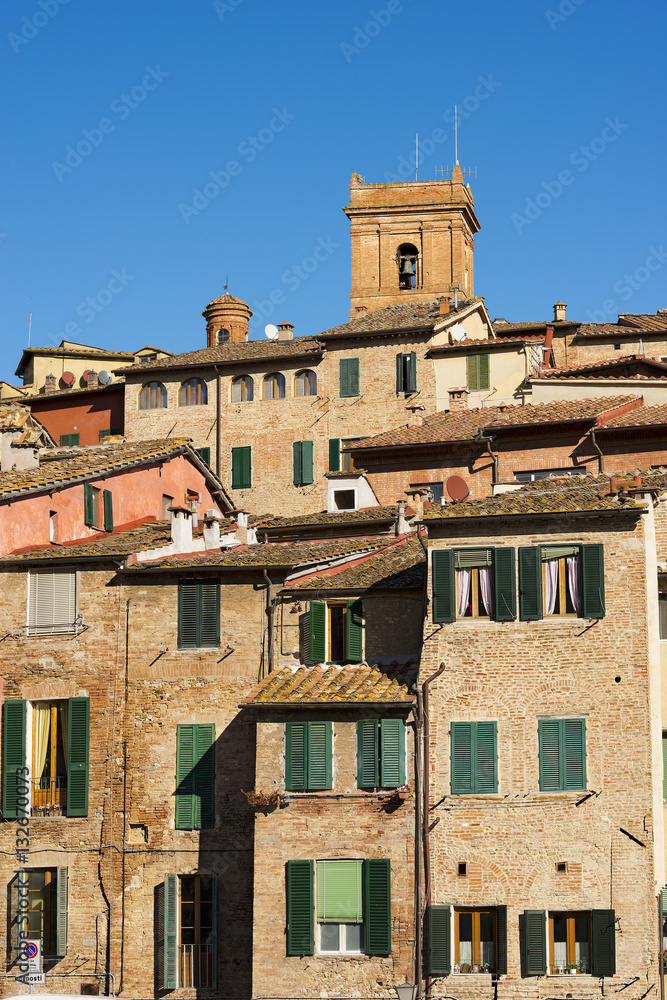 Siena with old houses and a bell tower. Tuscany, Italy, Europe
