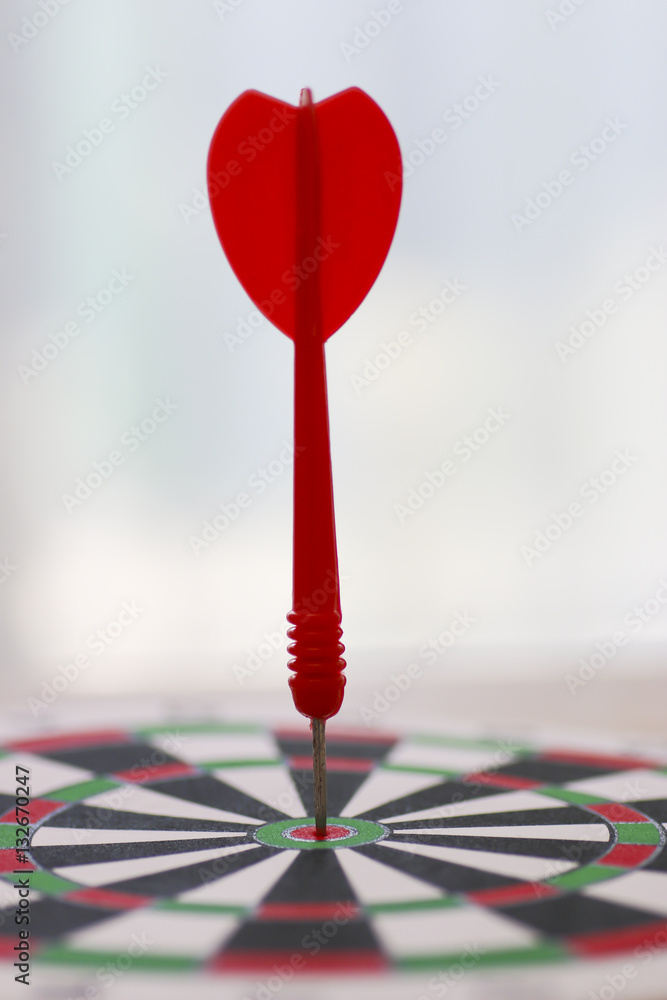 Stock Photo:.target dart with arrow over blurred bokeh backgroun Stock Photo:.target dart with arrow over blurred bokeh backgroun