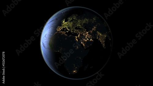 Satellite view of day-night transition above Africa with visible city lights on full planet Earth. Seemless loop