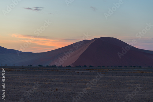 Colorful sunset over the Namib desert  Namibia  Africa. Scenic sand dunes in backlight in the Namib Naukluft National Park  Swakopmund.